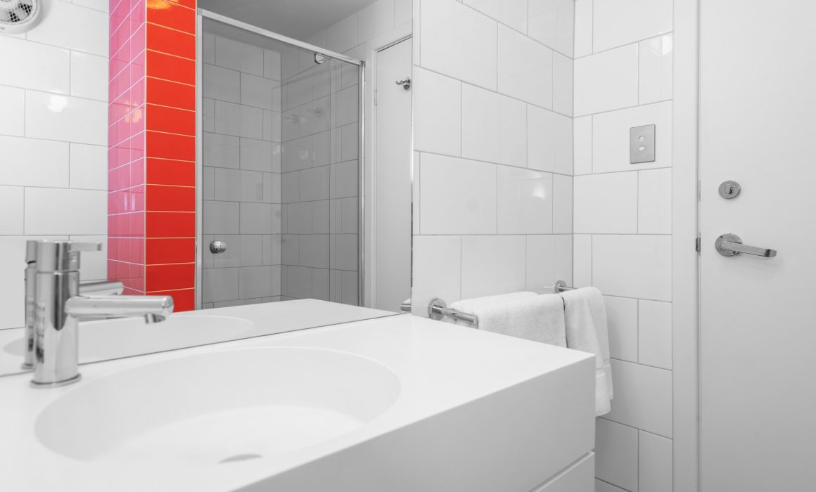 Sink in white and red bathroom