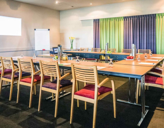 A function room in the Kalgoorlie Plaza Hotel, with chairs and tables arranged for a business conference