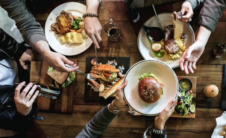 People sharing a meal, burger on plate