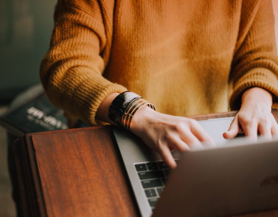 A business traveller works on their laptop