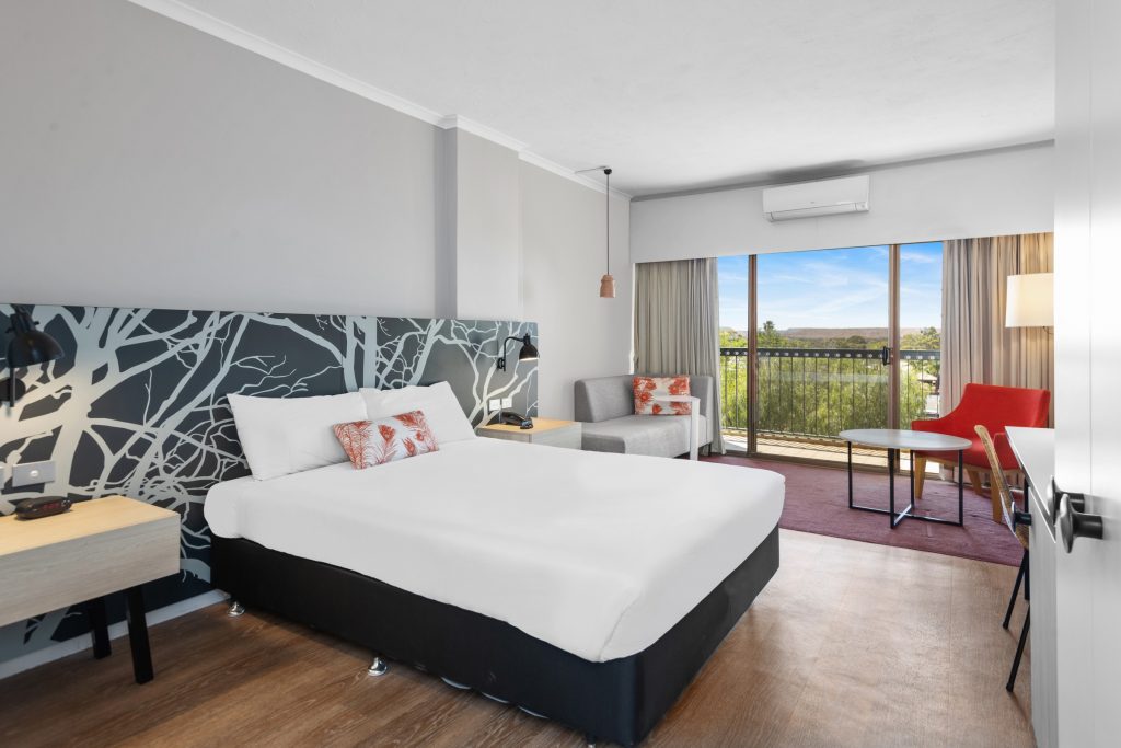 A hotel room at the Plaza Hotel Kalgoorlie, featuring a queen-size bed and balcony