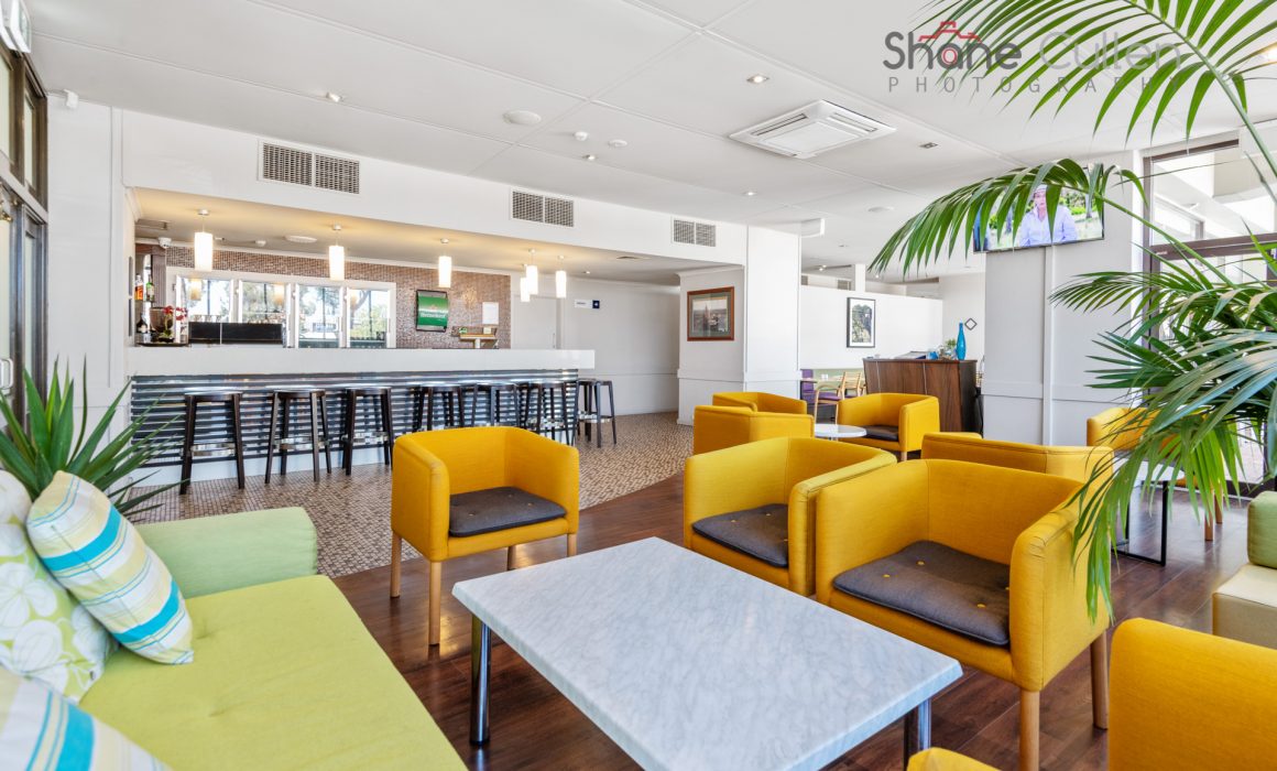 Bright yellow chairs and marble table at Plaza Hotel