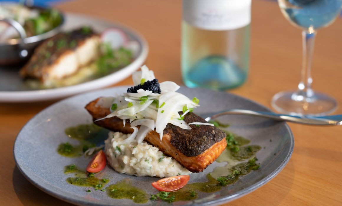 Salmon meal at the Kalgoorlie Plaza, on plate with wine glass