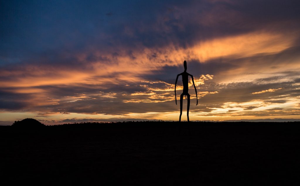 Statue at Lake Ballard near Kalgoorlie with sunset in the background